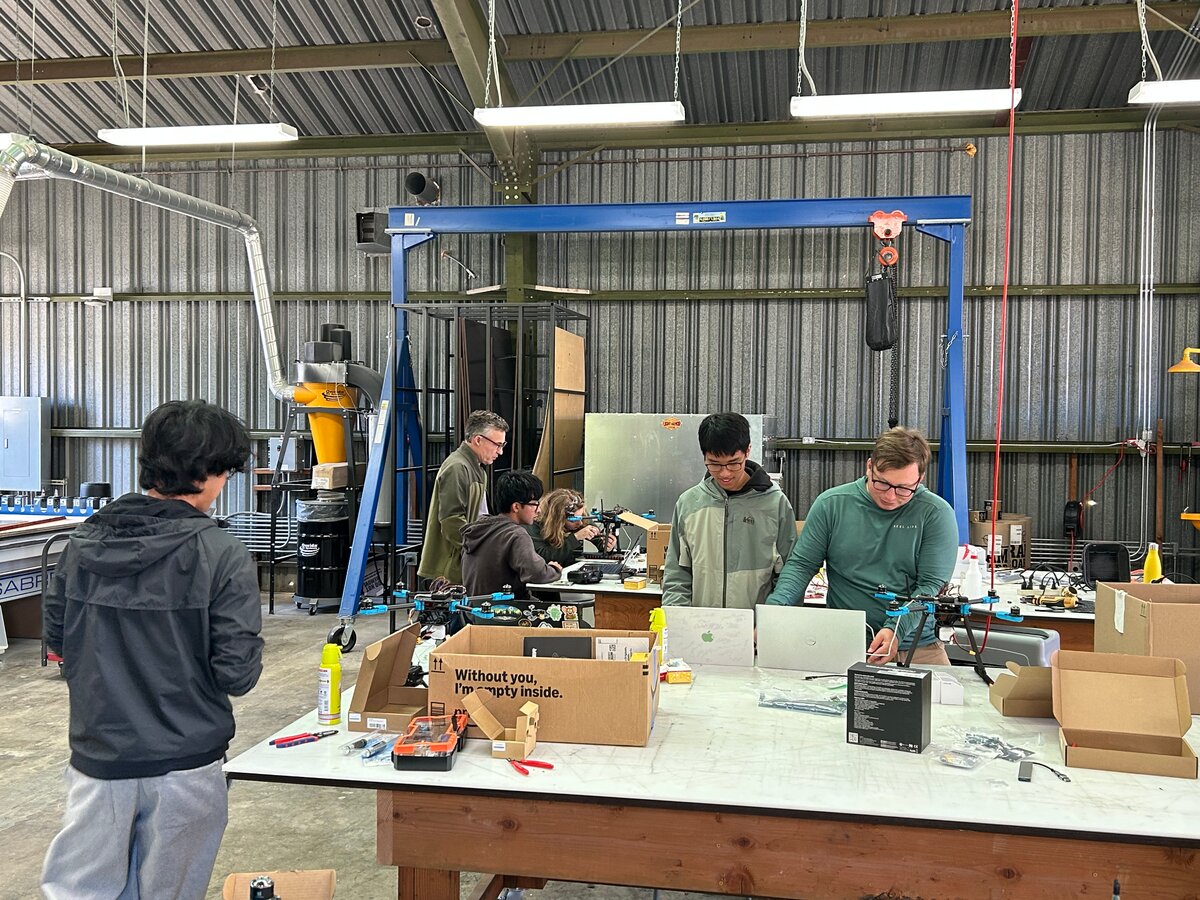 Students and mentors working on drones inside the SOAR shop